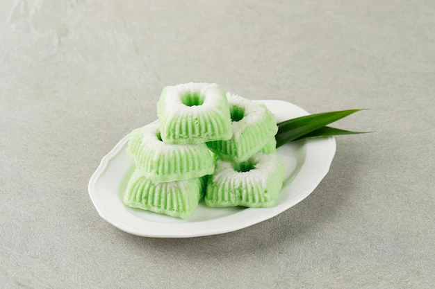 kue-putu-ayu-indonesian-traditional-jajan-pasar-made-from-steamed-flour-grated-coconut-usually-come-with-green-color-copy-space_511235-7883